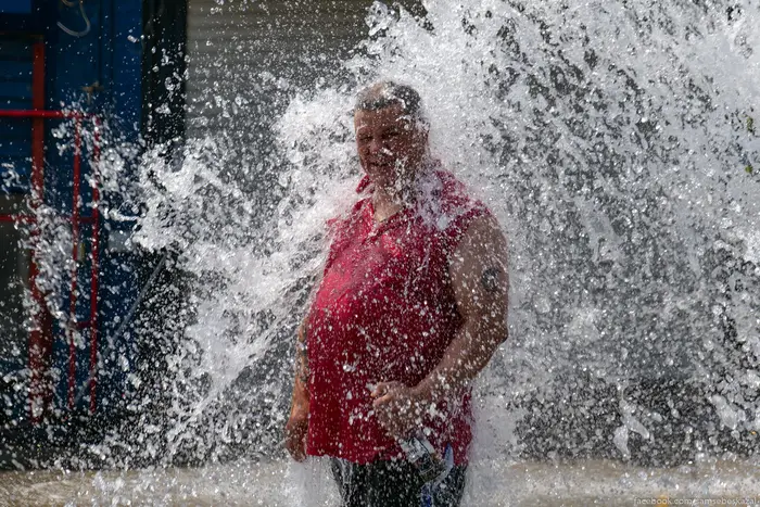 A photo of a man being doused by a fire hydrant